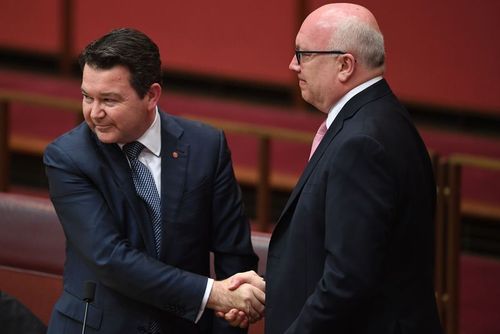 Mr Smith (left) is congratulated by George Brandis after introducing the Marriage Amendment Bill to legislate same-sex marriage. (AAP)