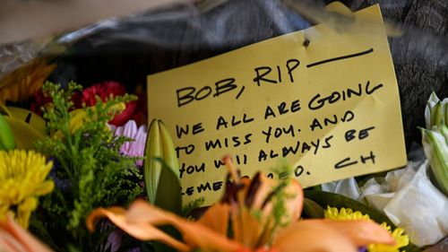 Mourners leave flowers and cards in honor of Bob Lee near the Portside apartment building in San Francisco on April 7.