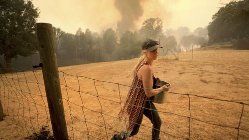 In total, 14,000 firefighters were battling blazes across California, which is seeing earlier, longer and more destructive wildfire seasons