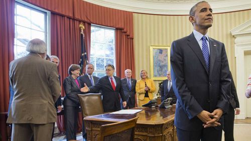 Al Franken (centre) in the Oval Office with then-president Barack Obama. (AAP)