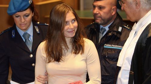 Knox smiles at her lawyer arriving at court in 2009. (AP)