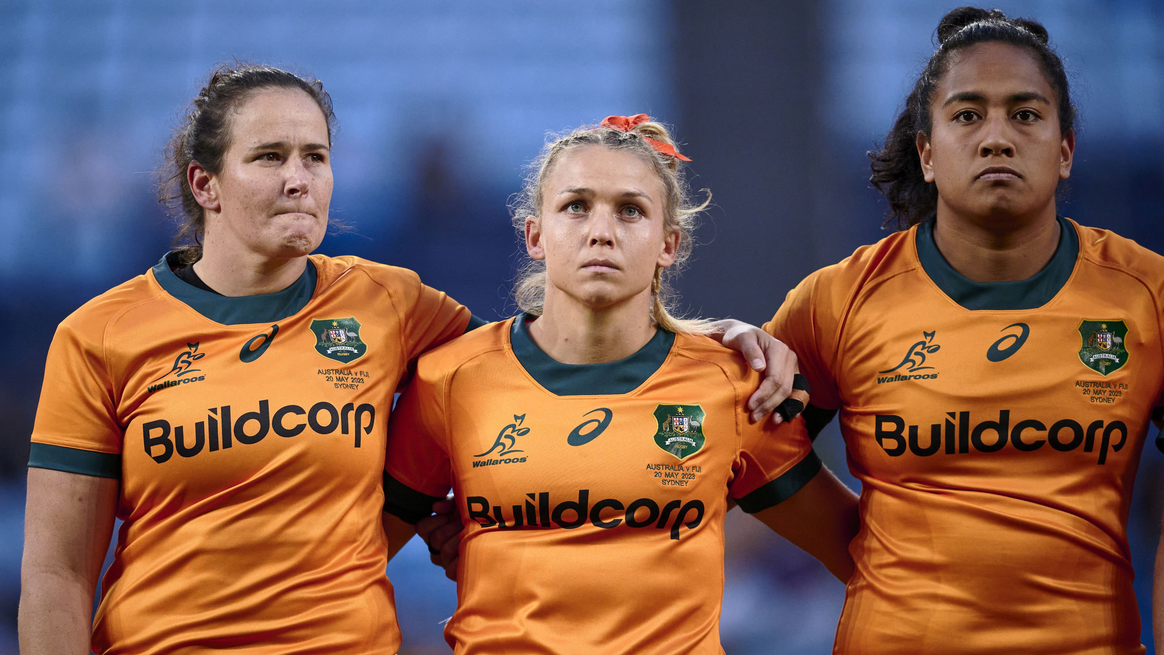  Shannon Parry, Georgina Friedrichs and Adiana Talakai of the Wallaroos stand for the anthems during the Women&#x27;s International match between the Australia Wallaroos and Fijiana at Allianz Stadium on May 20, 2023 in Sydney, Australia. (Photo by Brett Hemmings/Getty Images)