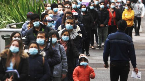 People wait at Sydney Olympic Park vaccination hub. 