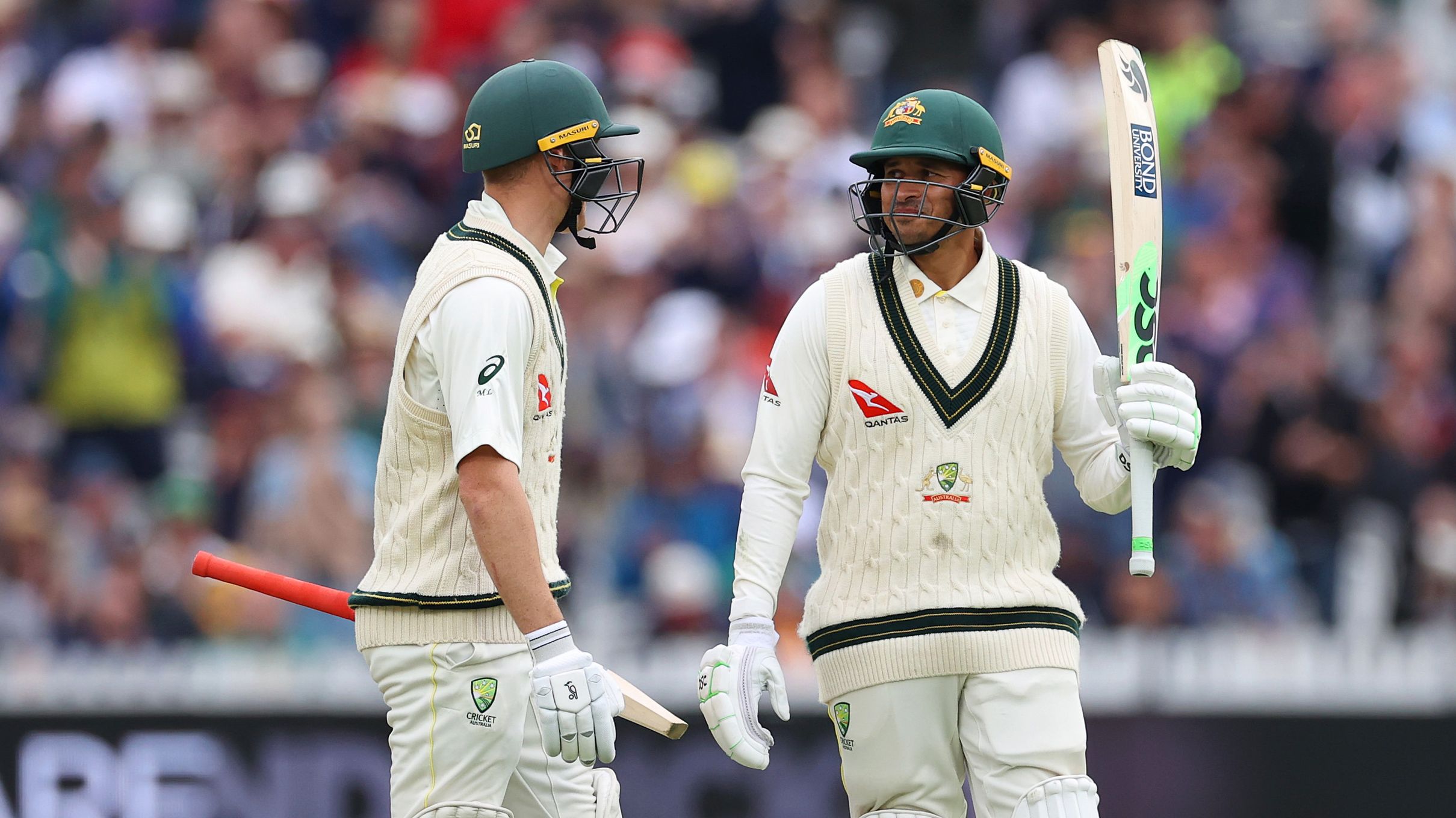 LONDON, ENGLAND - JUNE 30: Usman Khawaja of Australia raises his bat alongside teammate Marnus Labuschagne after scoring a half century during Day Three of the LV= Insurance Ashes 2nd Test match between England and Australia at Lord&#x27;s Cricket Ground on June 30, 2023 in London, England. (Photo by Ryan Pierse/Getty Images)