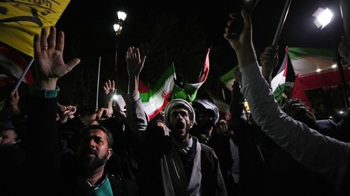 Iranian demonstrators chant slogans during their anti-Israeli gathering in front of the British Embassy in Tehran, Iran, early Sunday, April 14.