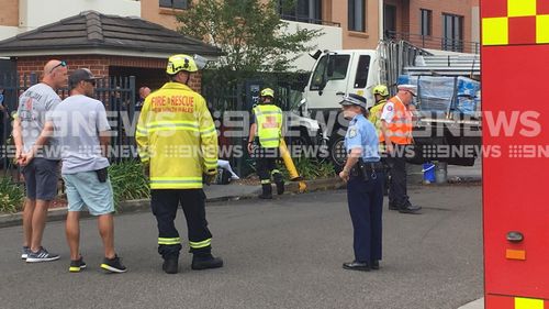 The truck reportedly hit a fire hydrant and four vehicles before crashing into a block of units.