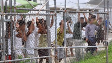 Protests broke out at Manus Island detention centre yesterday where refugees carried signs and chanted, demanding freedom. (AAP)