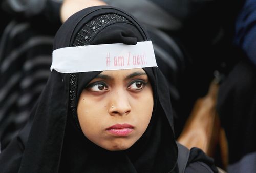 An Indian Muslim wearing a ribbon saying '#am I next' in a protest in Bangalore in April.