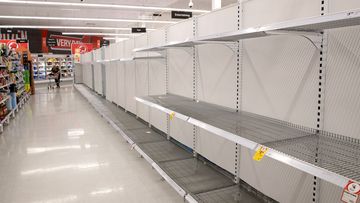 Empty toilet paper shelves in a Coles store in Sydney. Some customers have stockpiled toilet rolls and other essential items.