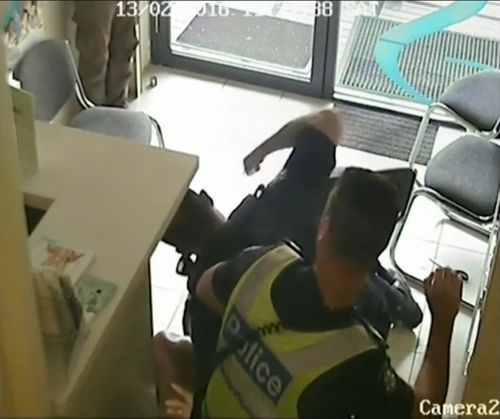 The man is punched by an officer. (Supplied)