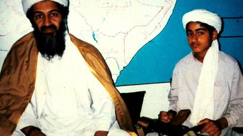 Osama bin Laden, now dead, sits with his young son Hamza, date unknown. (60 Minutes)