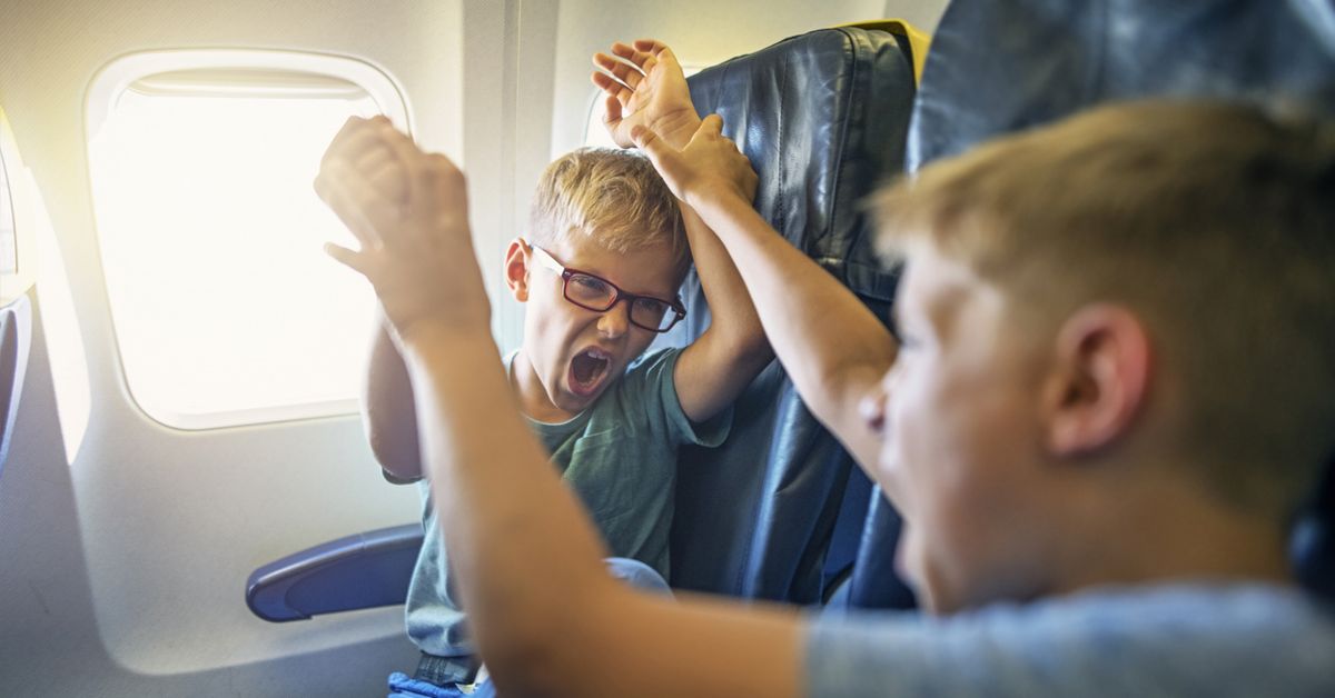 Here's how to handle rowdy kids on planes kicking the back of your seat