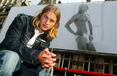 Australian model Travis Fimmel, the first new male face of Calvin Klein underwear for two years, in front of his image on a billboard March 1, 2002 on Tottenham Court Road in central London. 