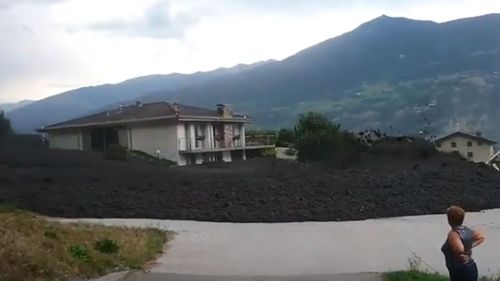The mudslide left a wall of debris in the Swiss village.
