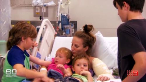 Rachael Moore's children comfort her in hospital. (60 Minutes)