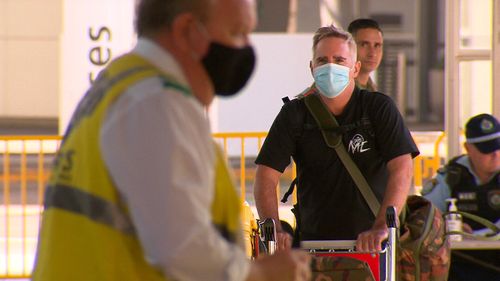 The AFR's Michael Smith moves through the international airport in Sydney.