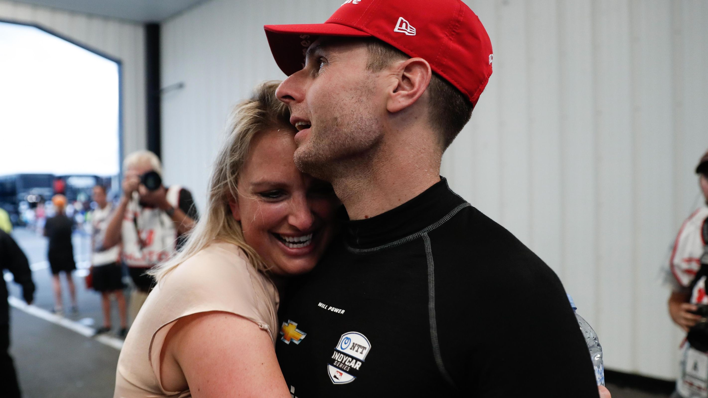 Liz Power (left) celebrates with husband Will after winning the 2019 IndyCar race at Pocono.