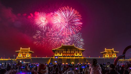People watch a fireworks show at Dingdingmen Square in Luoyang, China.