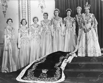 Queen Elizabeth II (right) wearing robes of state in the Throne Room at Buckingham Palace, London, on her coronation day.   Her Maids of Honour are beside her: (from left to right) Lady Moyra Hamilton, Lady Jane Vane-Tempest-Stewart, Lady Anne Coke, Lady Jane Heathcote-Drummond-Willoughby, Lady Rosemary Spencer-Churchill and Lady Mary Baillie-Hamilton. Standing next to the Queen is her Mistress of the Robes, Mary Cavendish, Duchess of Devonshire. (Photo by Keystone/Getty Images)