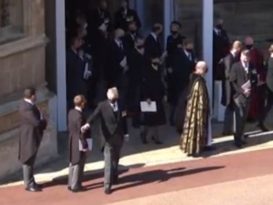 Man waves to car outside St George's Chapel after Prince Philip's funeral