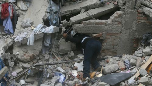 Desperate people dig through the rubble after the powerful earthquake. 