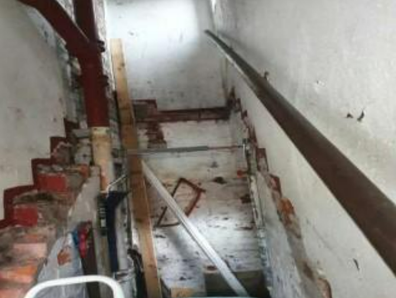 A rundown flat in Manchester without stairs has gone on the market, with a price guide of $39,703
