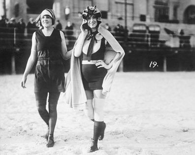 Two women wearing Annette Kellerman's full-body swimsuit designs on Atlantic City beach.