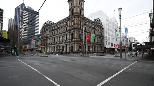MELBOURNE, AUSTRALIA - JULY 20: A quiet intersection is seen along Bourke Street on July 20, 2021 in Melbourne, Australia. Victoria is under strict lockdown as the state continues to record new community COVID-19 cases and work to stop the spread of the highly infectious delta coronavirus strain in the community. (Photo by Daniel Pockett/Getty Images)