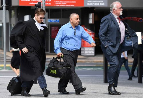 Former Roosters player John Touma (centre) arrives at the Supreme Court in Brisbane. (Image: AAP)
