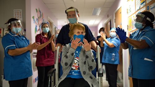 Margaret Keenan, 90, is applauded back onto her ward by nurses, after receiving the first Pfizer covid-19 vaccine at University Hospital Coventry.