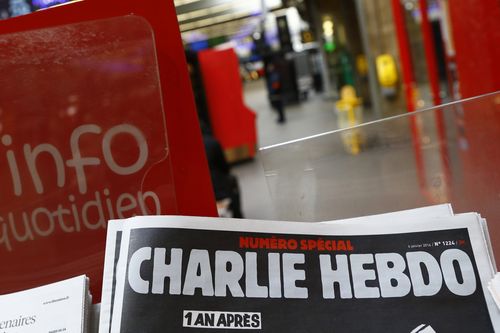 A special edition of the satirical newspaper Charlie Hebdo that marks one year after, "1 an apres" the attacks on it, on a newsstand Wednesday, Jan. 6, 2016 at a train station in Paris. 