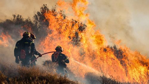 More than 200 firefighters are struggling to tackle an out-of-control wildfire on Crete — Greece's largest island and a tourist hotspot — as authorities order mass evacuations.