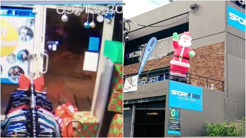 The thief swiftly walked past the store to his target: the inflatable Santa. (Supplied)