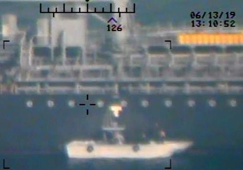Photo taken from a US Navy helicopter showing what the Navy says are members of the Islamic Revolutionary Guard Corps Navy removing an unexploded limpet mine from the M/T Kokuka Courageous. 