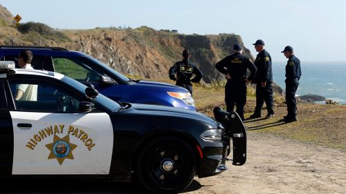 California Highway Patrol officers and deputy sheriffs from Mendocino and Alameda counties gather after a search for the three missing children. (AP)