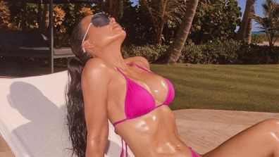 Kim Kardashian poses in pink bikini