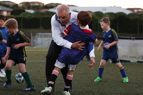 Prime Minister Scott Morrison accidentally knocks over a child during a visit to Devonport Strikers Soccer Club, which is in the Braddon electorate of Devonport, Australia. 