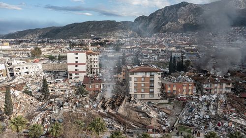 Smoke billows from the scene of a collapsed buildings on February 07, 2023 in Hatay, Turkey.