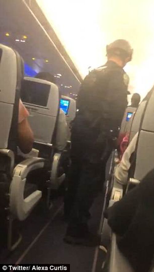 Passengers were ordered to put their hands in the air when their flight was stormed on Tuesday night. (Twitter @Alexa_Curtis)