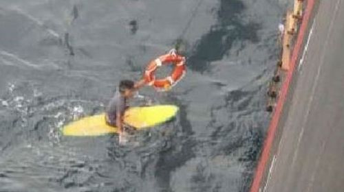 Stranded surfer survives night at sea clinging to board