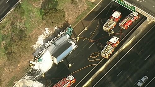 Emergency crews are working to free a trapped car. (9NEWS)