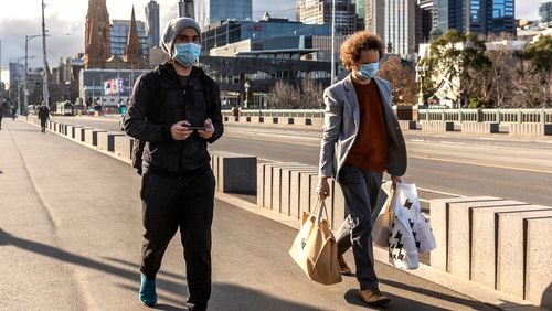 Pedestrians walk away from the central business district in Melbourne.