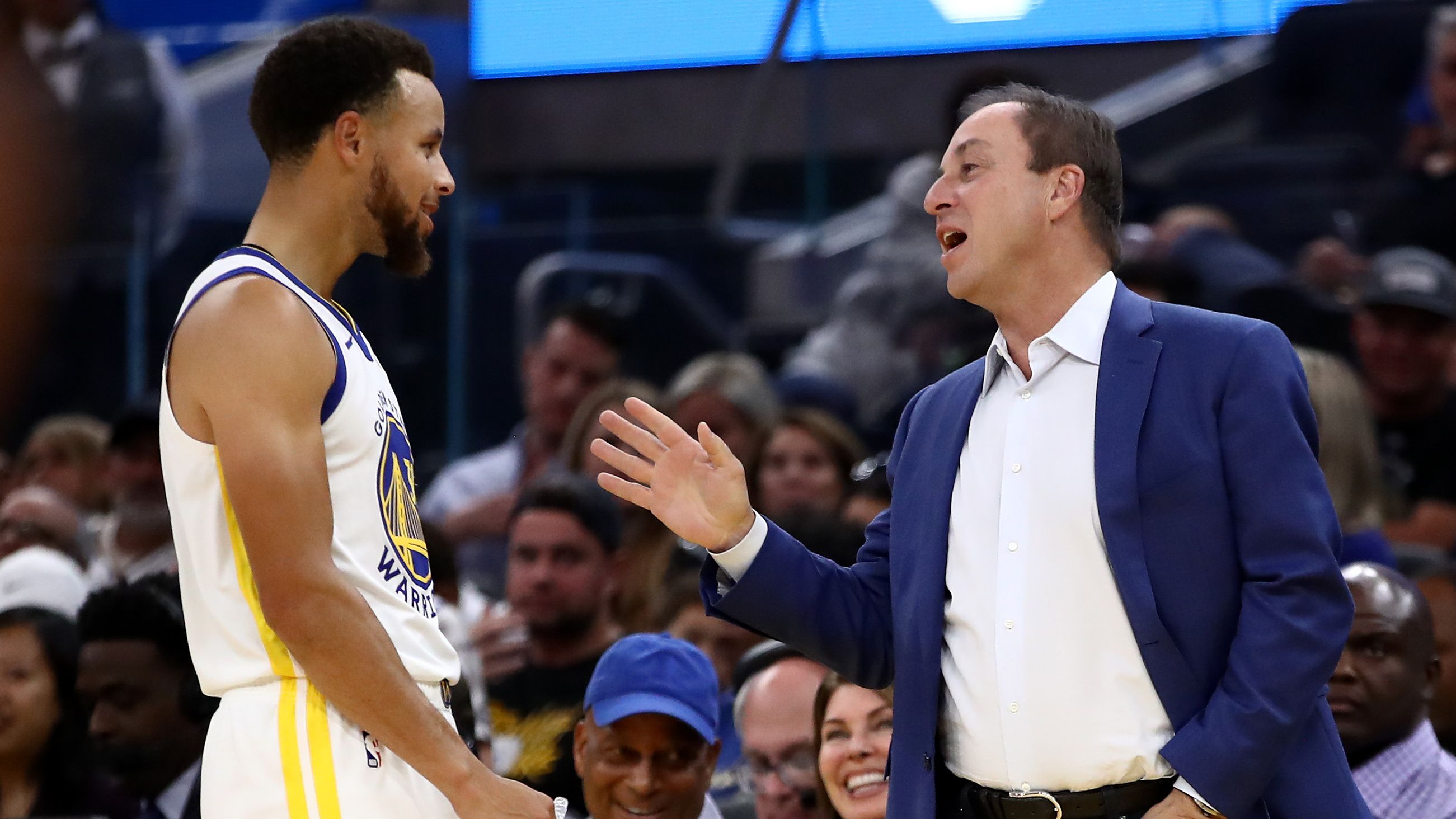 Golden State Warriors owner Joe Lacob speaks to superstar Stephen Curry.
