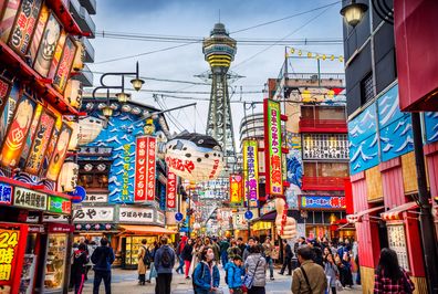 View of Osaka Tower and from Shinsekai district at dusk. Osaka, Japan.