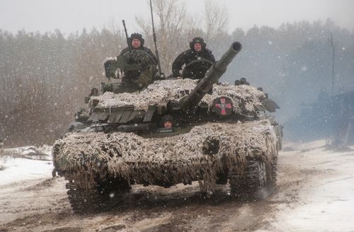 A Ukrainian tank moves during military drills close to Kharkiv, Ukraine, Thursday, Feb. 10, 2022. Britain's top diplomat has urged Russia to take the path of diplomacy even as thousands of Russian troops engaged in sweeping maneuvers in Belarus as part of a military buildup near Ukraine. (AP Photo/Andrew Marienko)