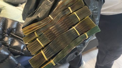 Cash seized by police in a raid yesterday.