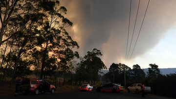 Police form a road block at a bushfire in North Nowra, 160km south of Sydney, Saturday, January 4, 2020.