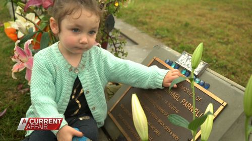 Mr and Mrs Parnell's two-year-old daughter Heidi at her father's grave.