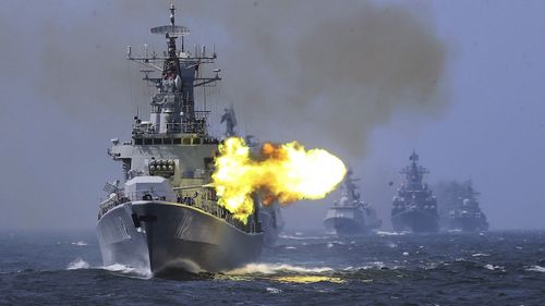 A Chinese destroyer fires its guns during a drill.