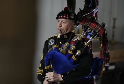 A bagpiper plays during the State Funeral of Queen Elizabeth II at Westminster Abbey in central London, Monday, Sept. 19, 2022. The Queen, who died aged 96 on Sept. 8, will be buried at Windsor alongside her late husband, Prince Philip, who died last year. (AP Photo/Frank Augstein, Pool)
